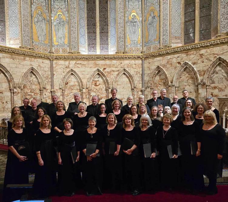 A photo of Cr Mhaigh Eo choir perfoming in Holy Trinity Chuch, Westport, with conductor, Kathy Quinn, front right